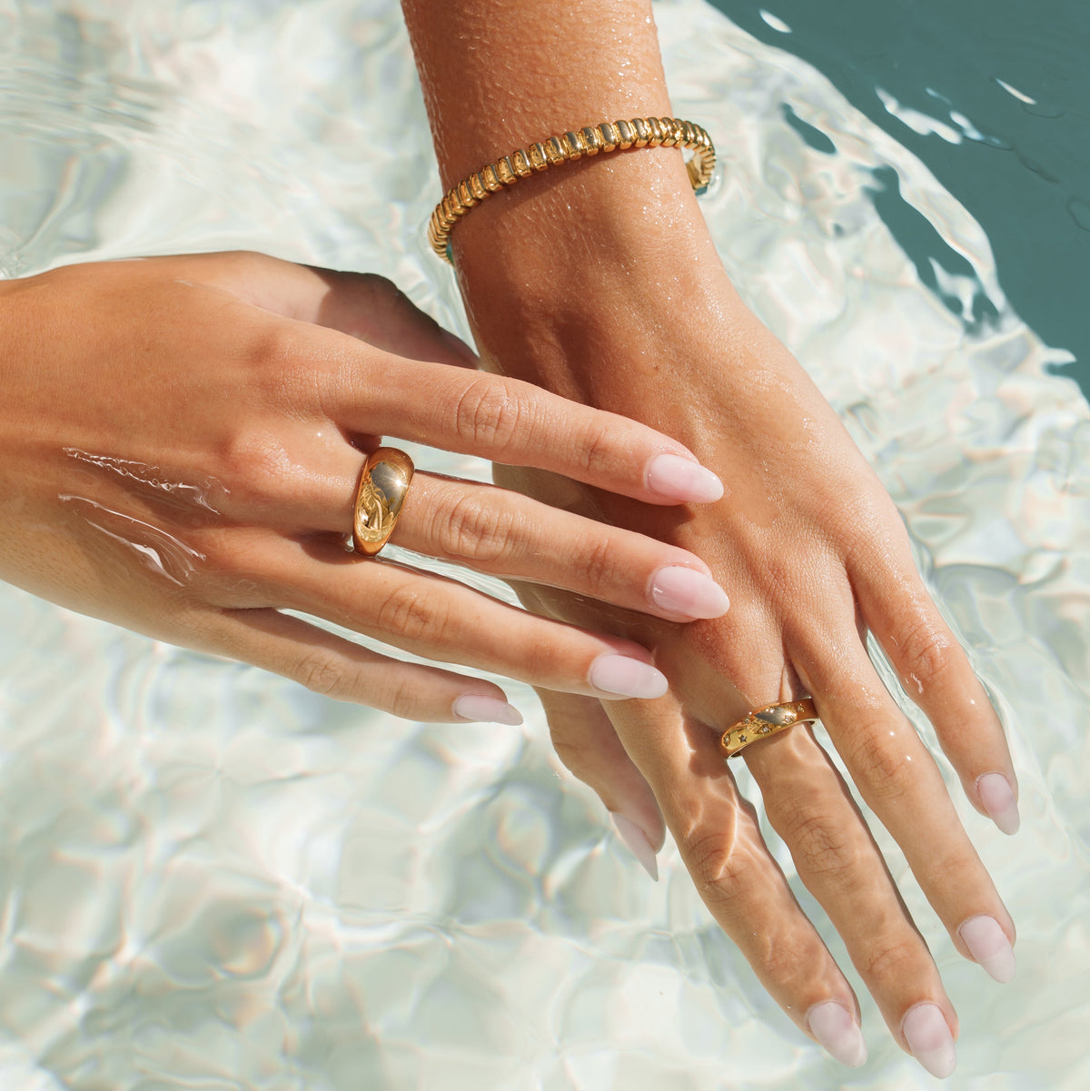 woman wearing morea waterproof gold jewelry in water