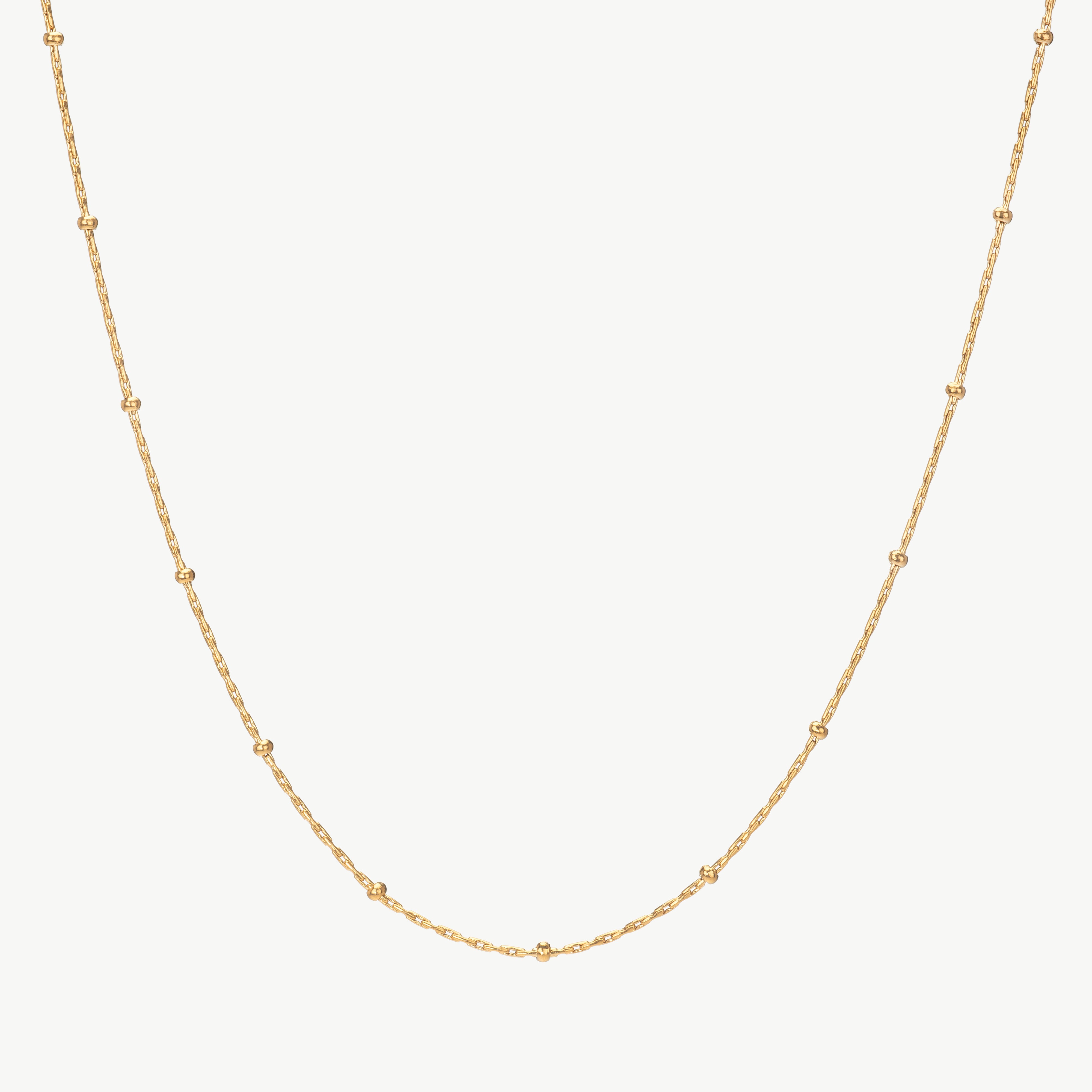 beaded chain necklace in gold with spaced accents, gold satellite chain necklace styled as a station necklace gold with beaded station necklace detail along the chain