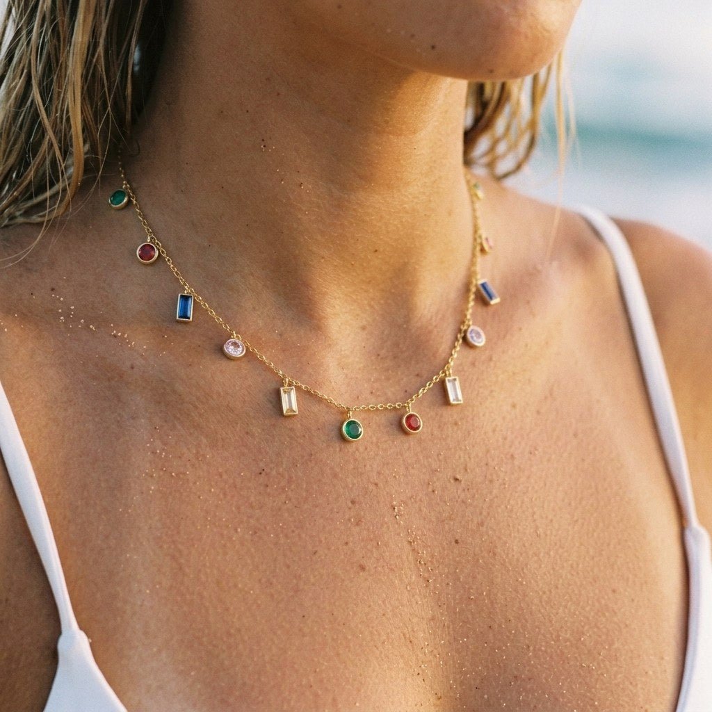 bezel set gemstone necklace with multicoloured stone charms spaced along a delicate gold chain