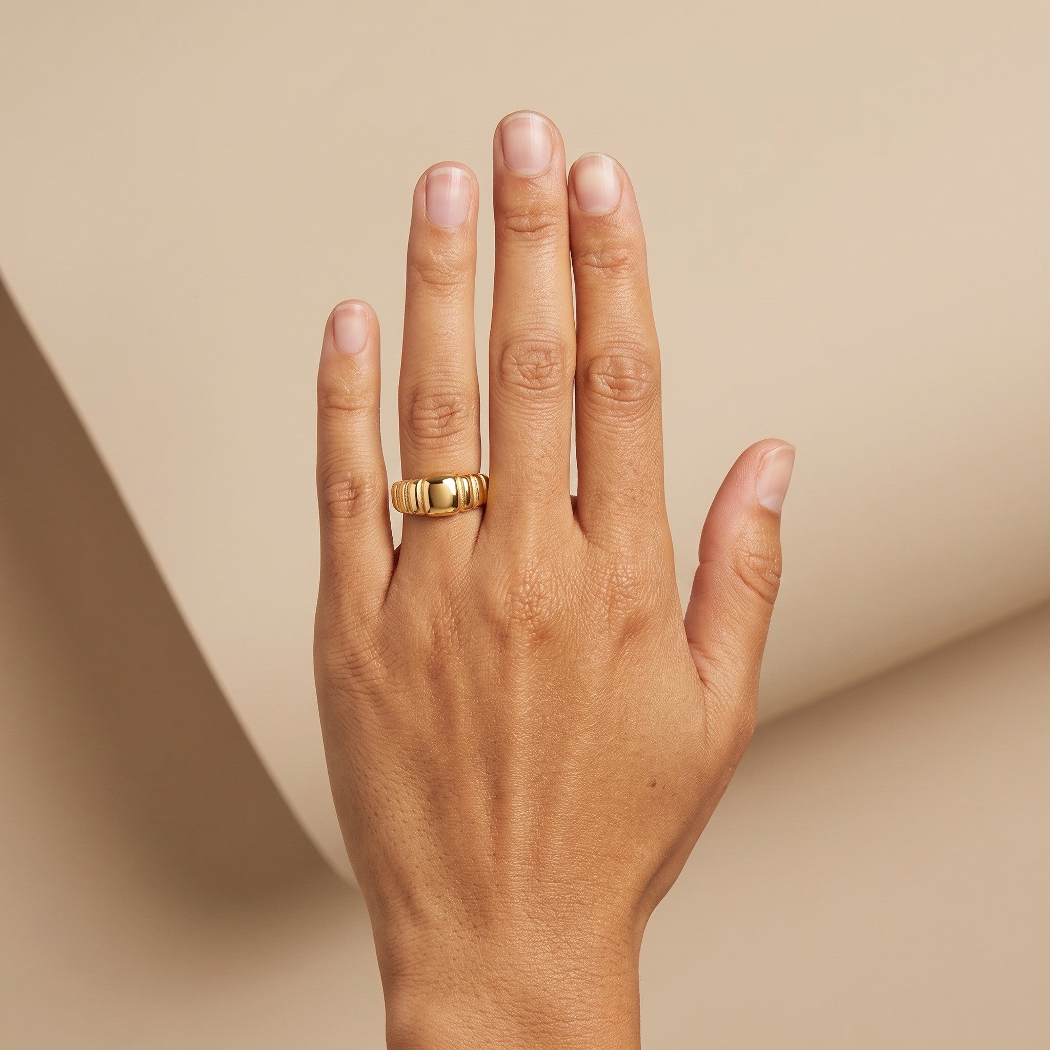 bold signet ring with a smooth polished center and bold ribbed detailing