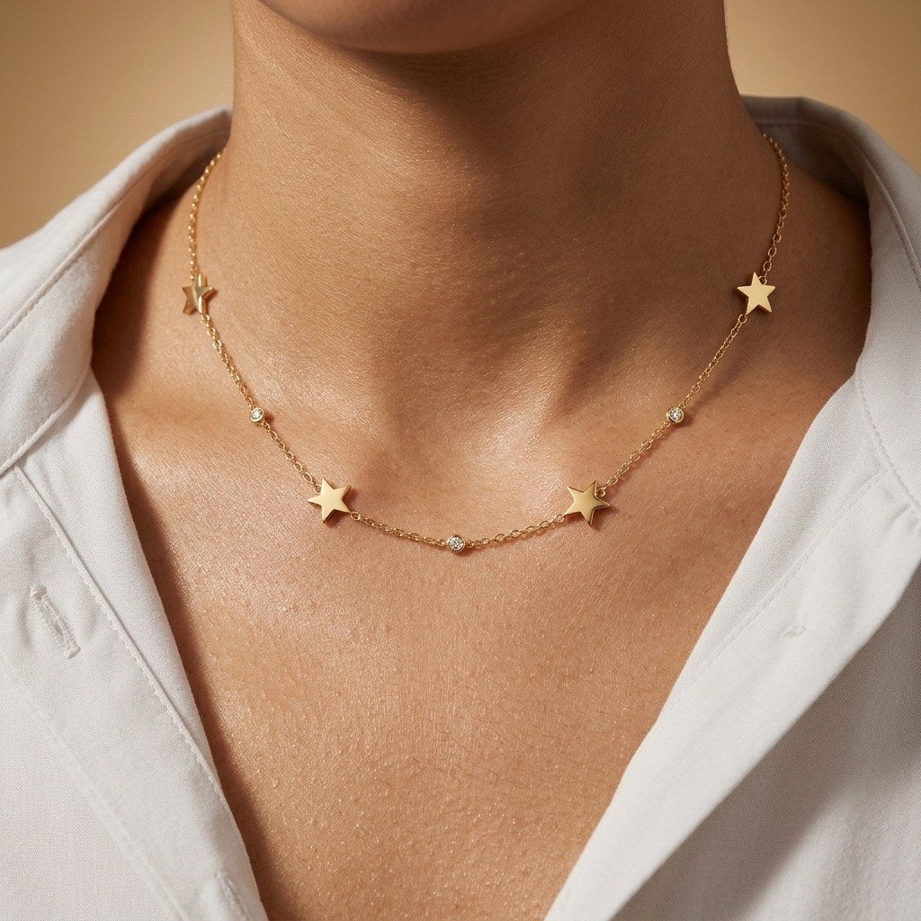celestial star charm necklace in gold with scattered stars and delicate crystal details