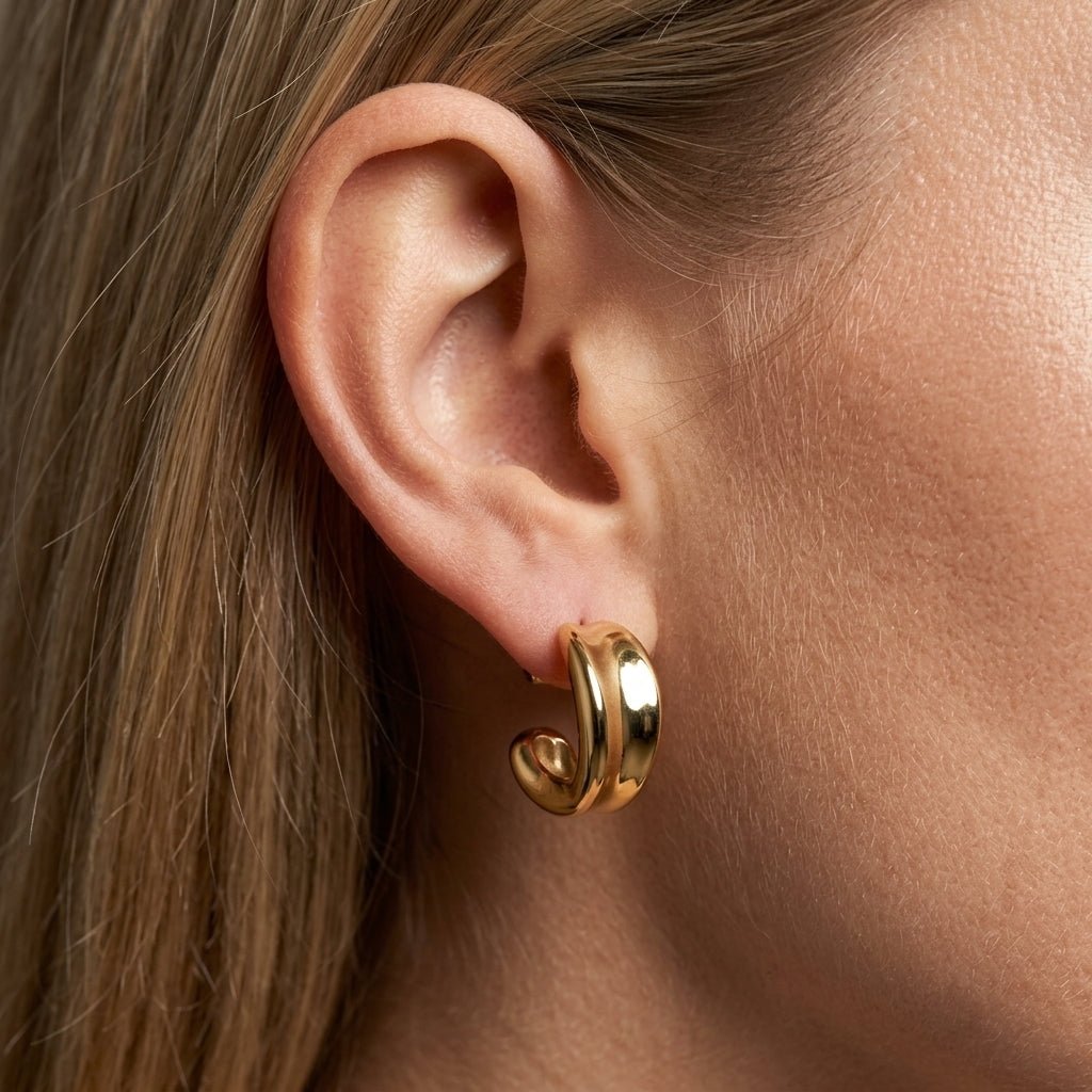 chunky gold dome hoop earrings sculptural gold dome hoop earrings with a bold curved shape and glossy finish inspired by modern luxury jewelry trends