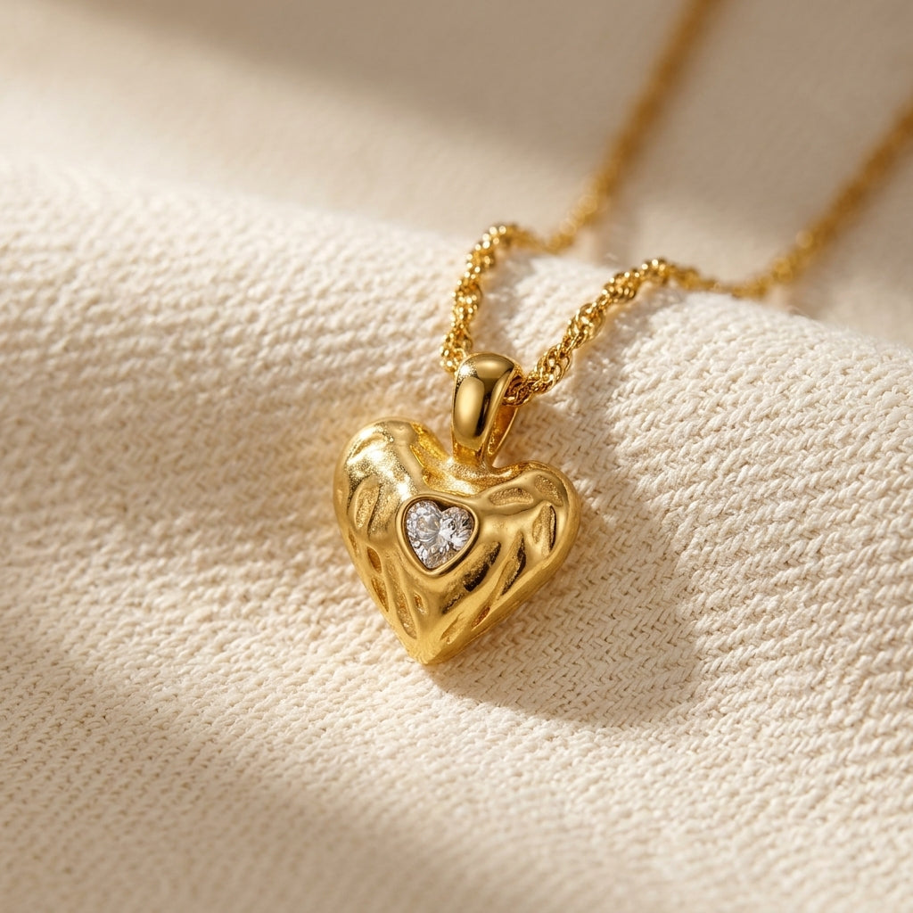 chunky gold heart charm necklace featuring a bold polished heart pendant with an embossed design and sparkling crystal accent for everyday jewelry styling