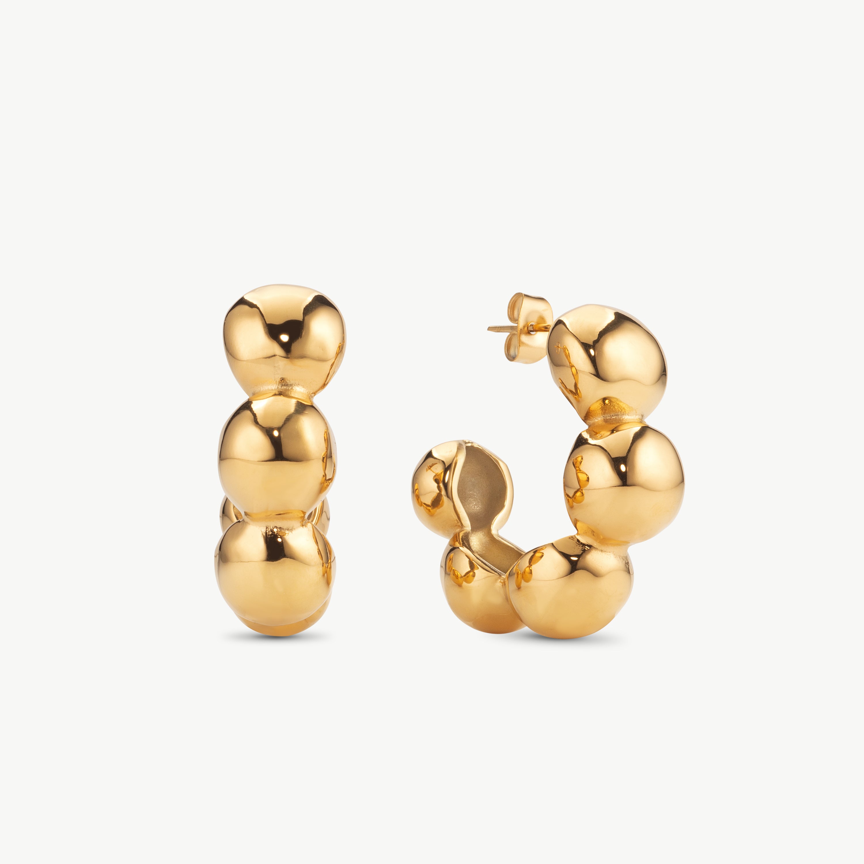 chunky gold hoop earrings with smooth rounded shape, bold statement hoop earrings with polished finish and modern sculptural form and gold bubble hoop earrings
