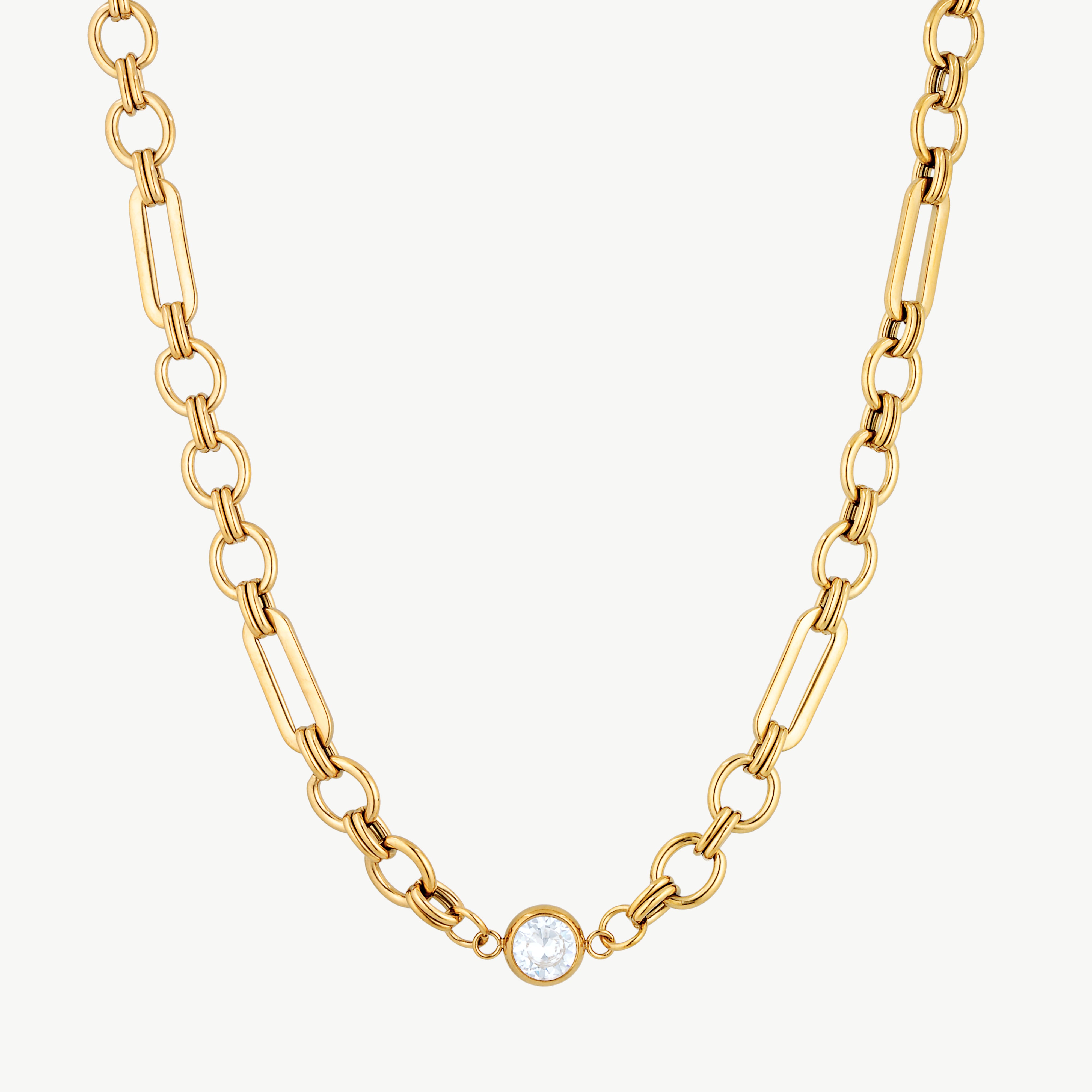 chunky gold link necklace with polished oval links and round cubic zirconia centerpiece in a modern statement design