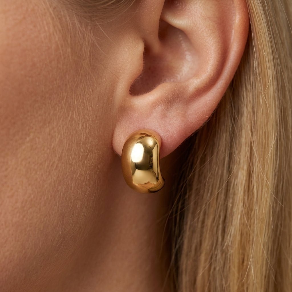 chunky gold stud earrings oversized gold dome stud earrings with a glossy sculptural finish and bold minimalist silhouette for modern statement styling