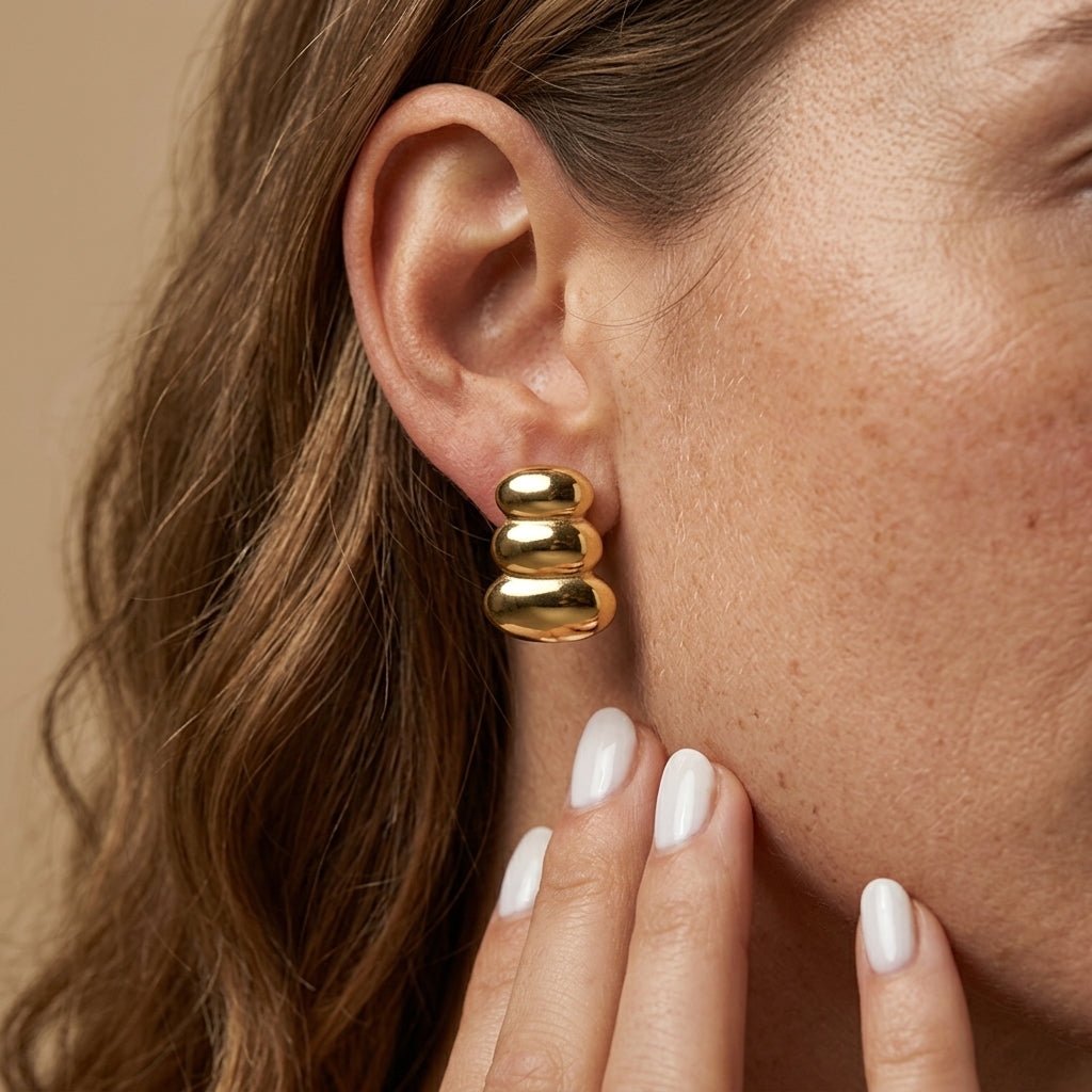 chunky stud earrings bold sculptural gold stud earrings with a stacked dome design and high-shine finish, creating a striking fashion-forward statement inspired by contemporary runway jewelry trends and gold dome earrings design