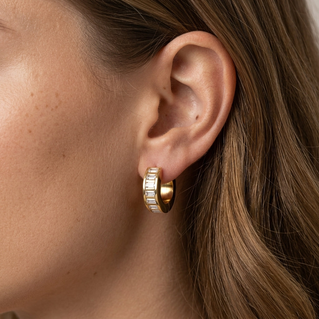 crystal baguette earrings featuring a row of brilliant rectangular cut clear stones in chunky gold hoops for a modern statement jewelry style