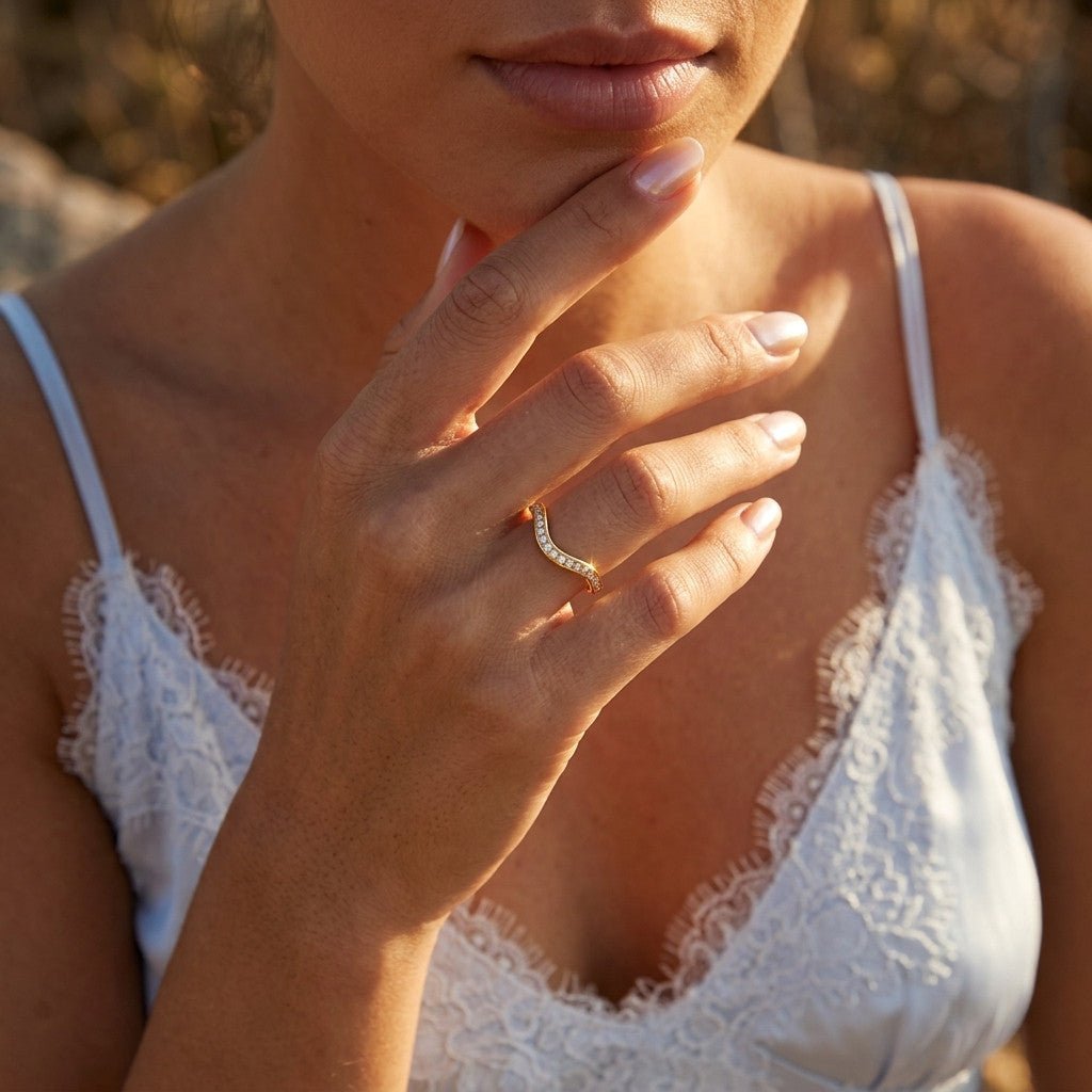 curved stacking band with sparkling clear stones set along a polished gold v shaped design