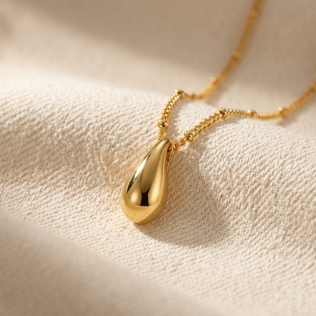dainty teardrop pendant necklace with a smooth gold drop