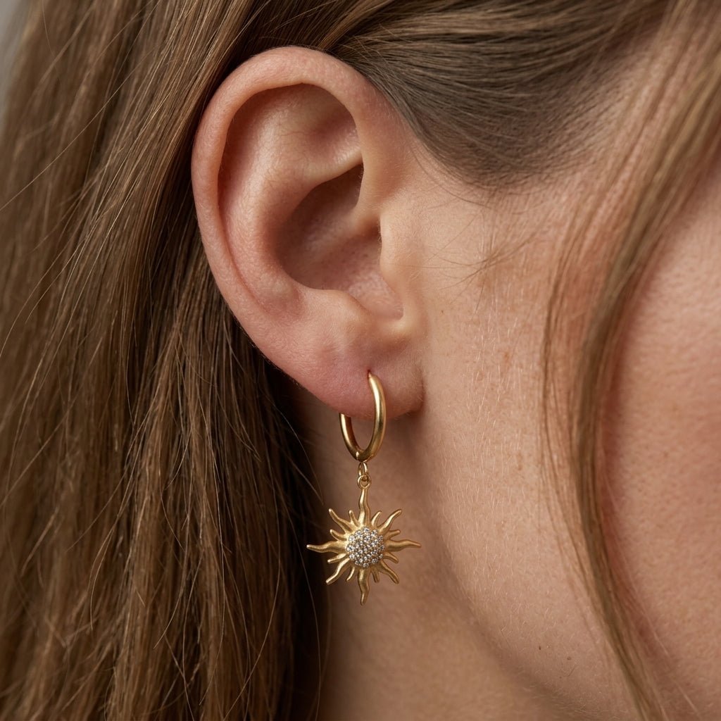 dangling sun earrings gold sun charm hoop earrings with sparkling crystal details for a celestial inspired boho jewelry look