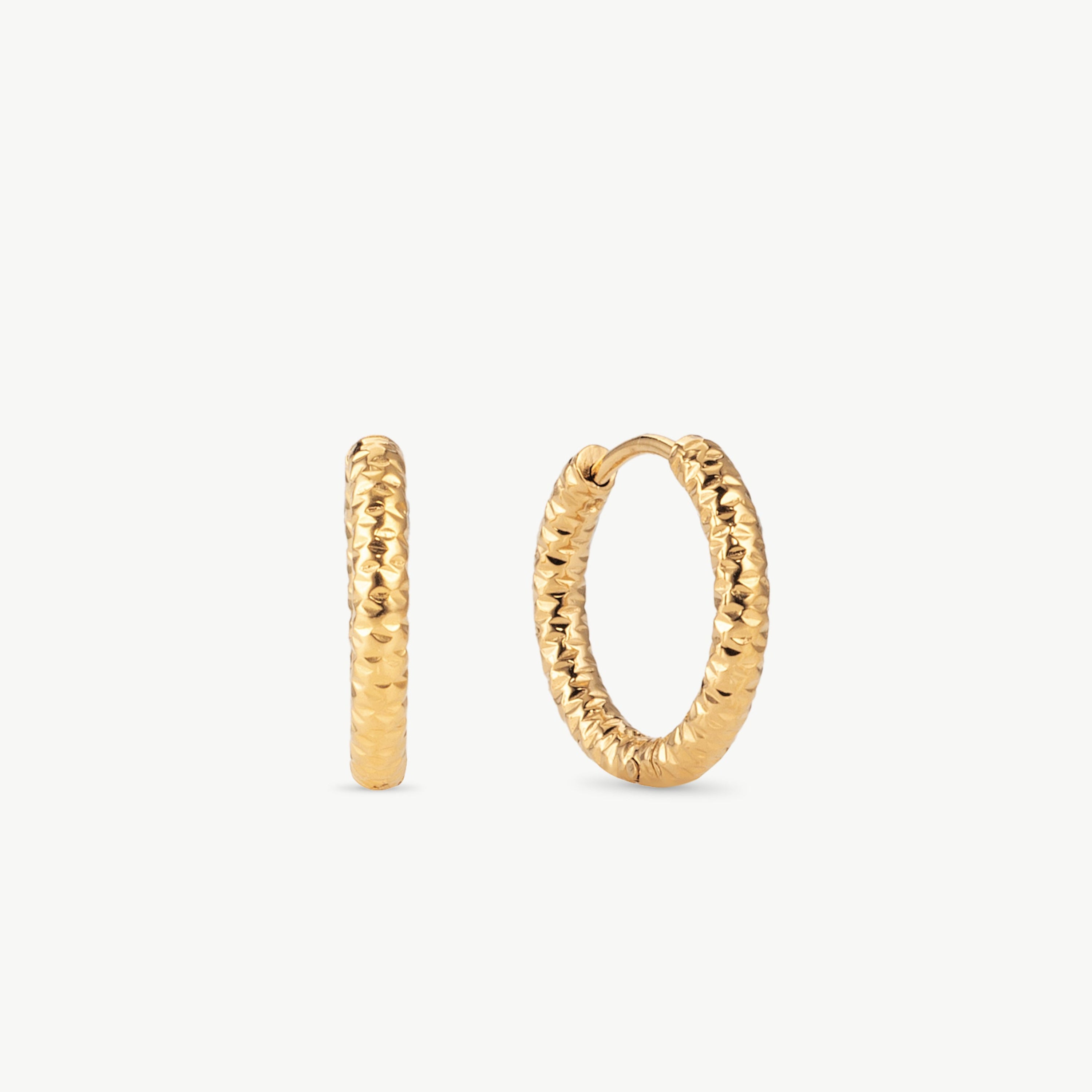 diamond cut huggie earrings in gold with faceted surface, gold huggie hoop earrings with textured gold hoop earrings finish and subtle shine