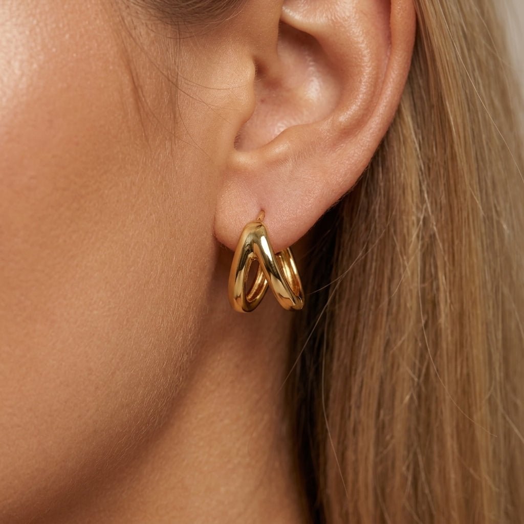 double hoop huggie earrings sculptural gold double hoop earrings with a chunky layered design and polished finish for a sleek modern statement look