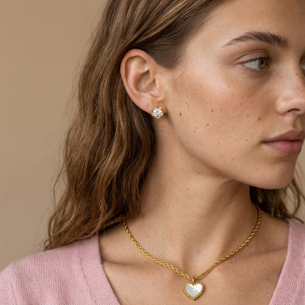 elegant gold heart charm necklace for women featuring a glossy white heart pendant paired with gold stud earrings for a romantic jewelry gift for her