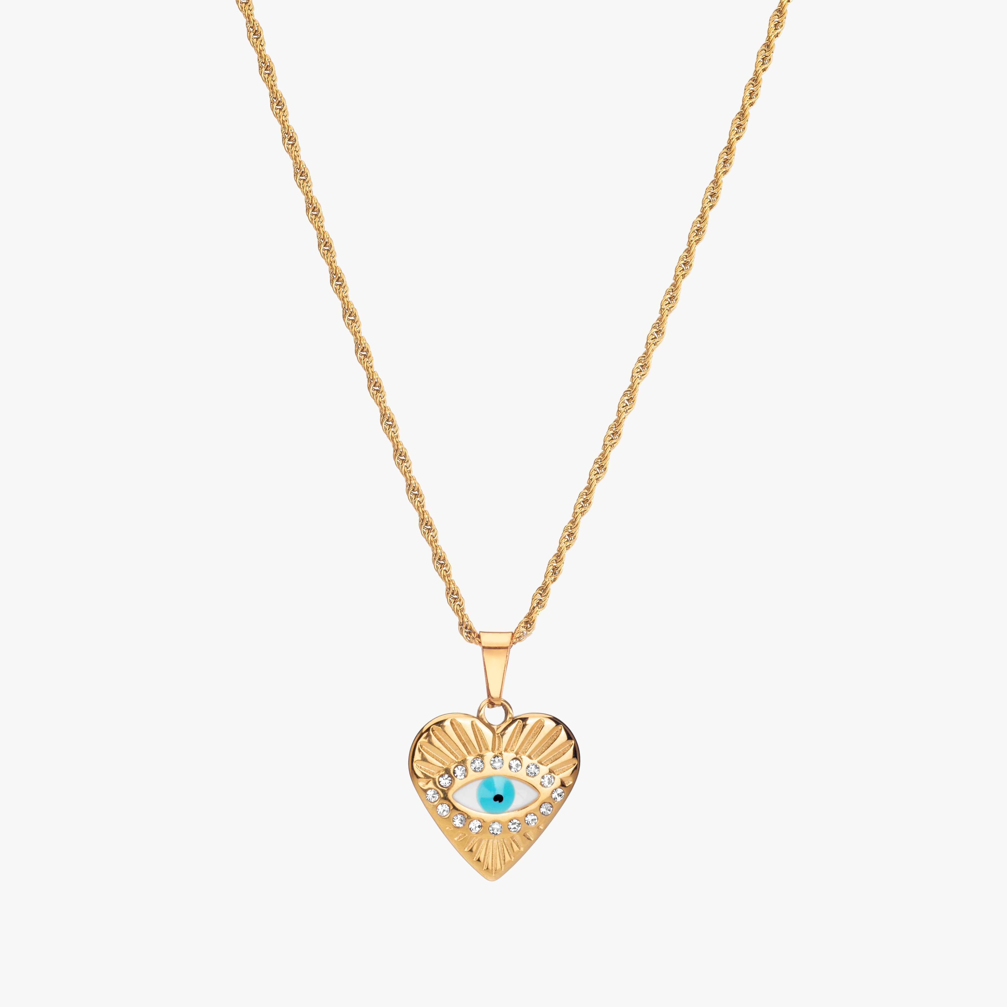 evil eye heart necklace in gold with heart shaped charm and eye detail, gold evil eye necklace styled as a dainty evil eye necklace centered on the chain