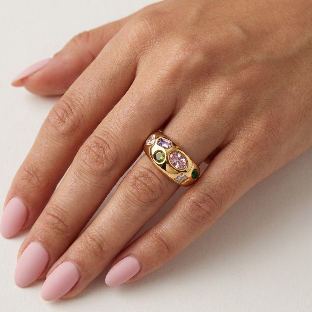 gemstone statement ring with colorful mixed stones set across a wide polished gold band