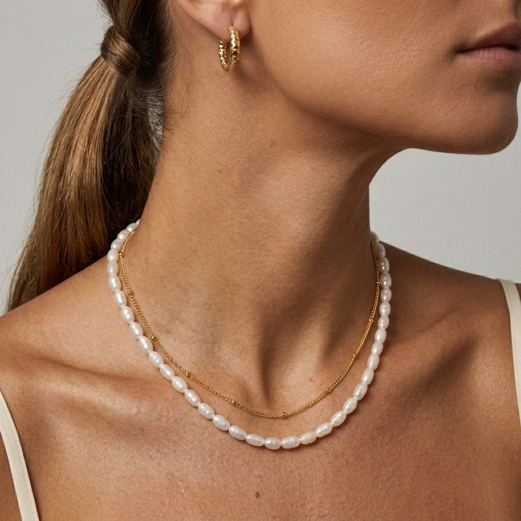 gold and pearl necklace with white freshwater pearls layered with a delicate gold chain