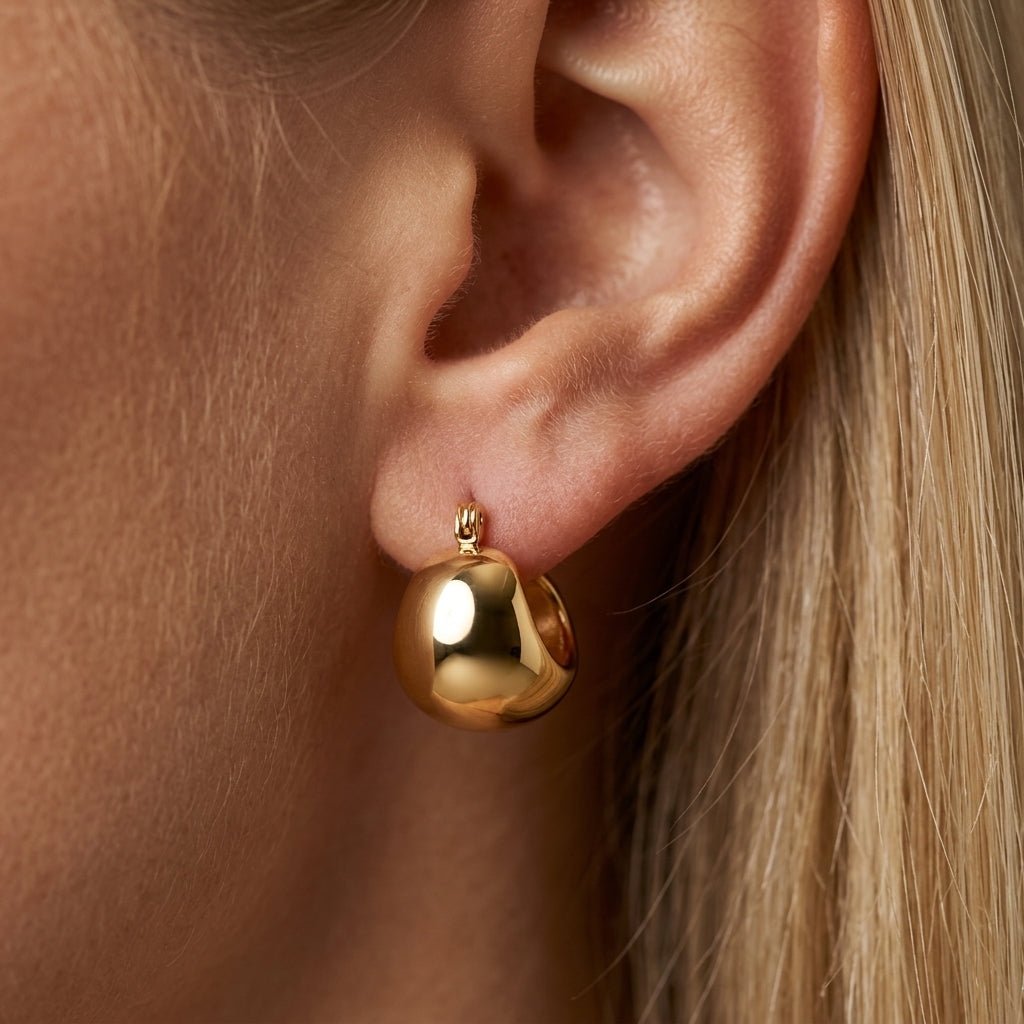 gold chunky earrings bold gold huggie earrings with a rounded chunky silhouette and mirror polished finish for elevated everyday styling