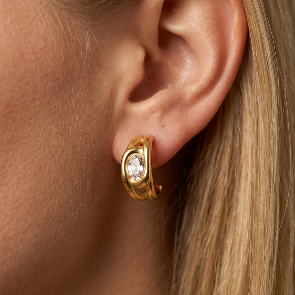 gold crystal hoop earrings contemporary gold hoop earrings featuring a bezel-set faceted crystal centerpiece with smooth sculptural curves, delivering a refined designer-inspired gold gemstone earrings look with subtle sparkle and bold modern character
