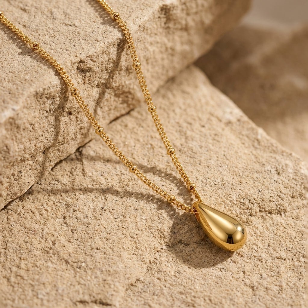 gold droplet necklace with a polished teardrop pendant