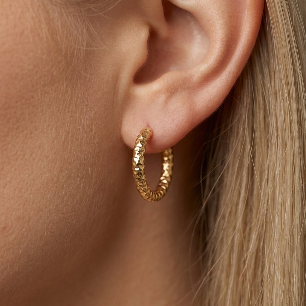 gold huggie earrings classic gold hoop earrings with an intricate textured pattern and polished finish, designed in a sleek huggie style for a refined everyday look with subtle statement detail and contemporary appeal