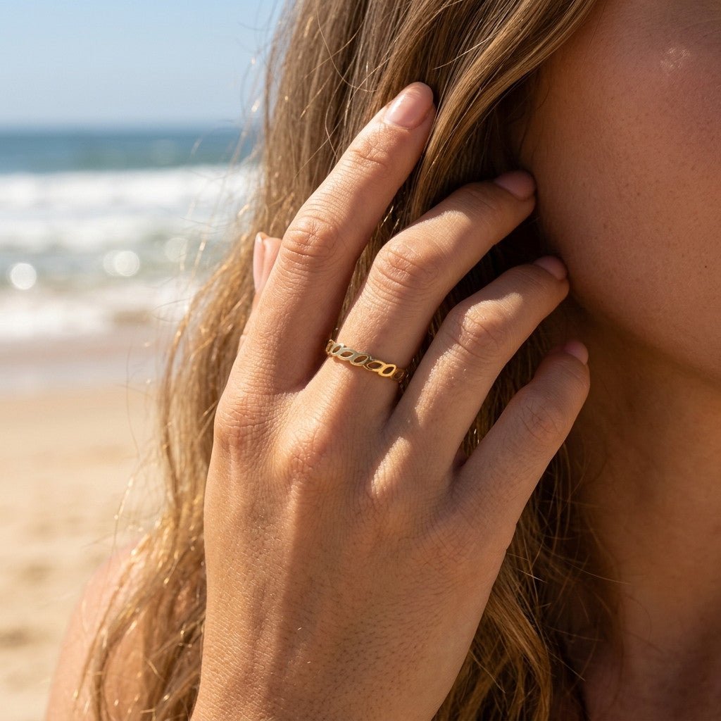 gold leaf ring with an open botanical band and polished finish, worn on hand