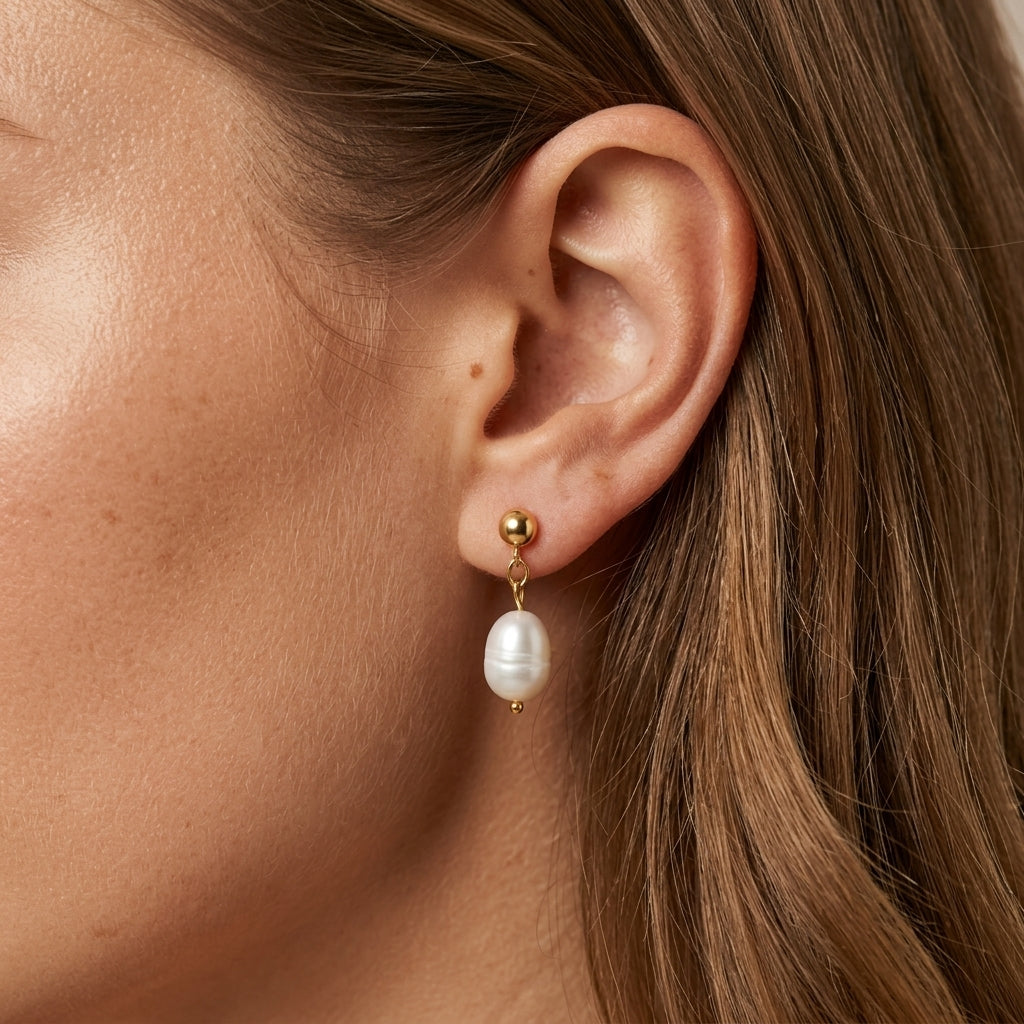 gold pearl drop earrings featuring a white freshwater pearl