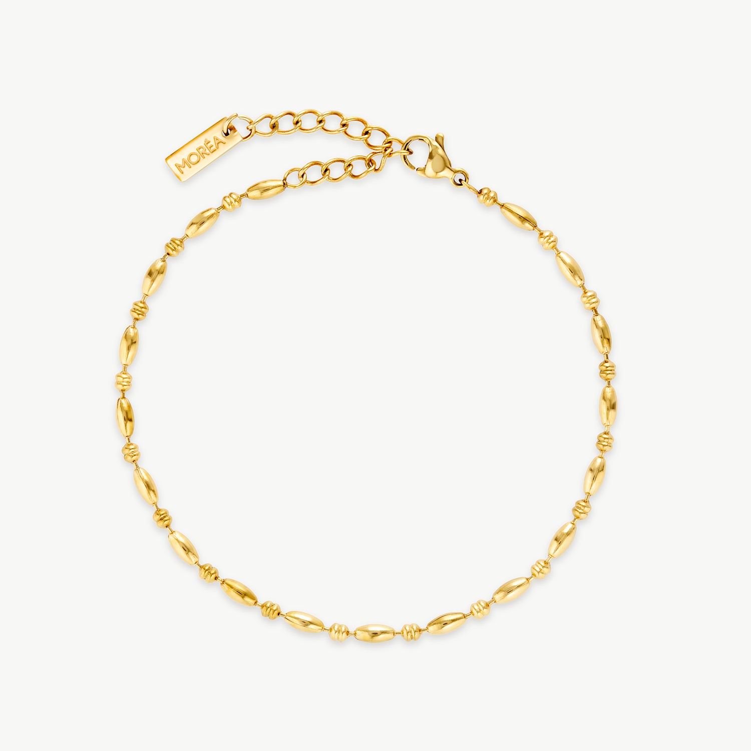 gold rice bead bracelet with polished elongated oval beads on a delicate gold chain