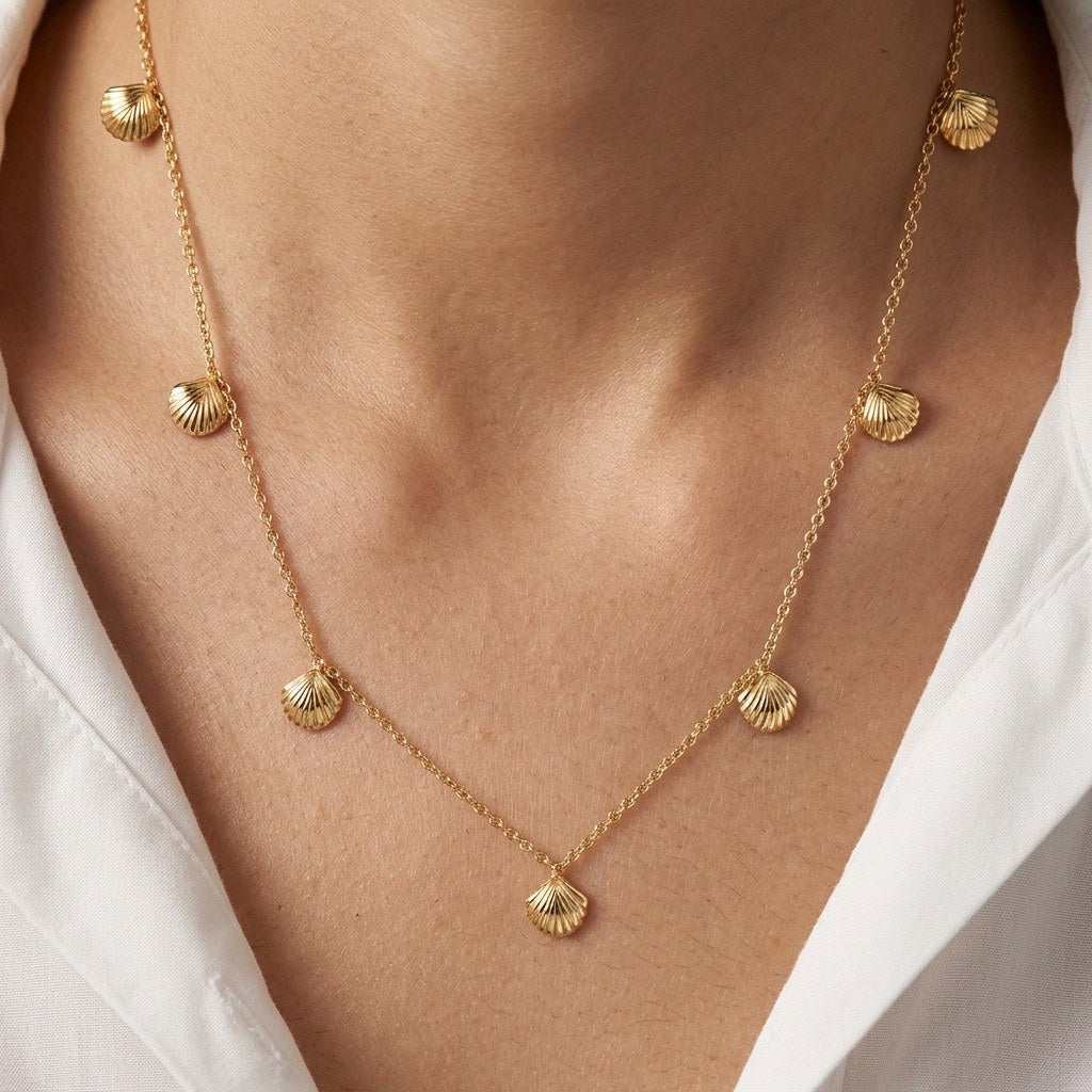 gold shell station necklace featuring evenly spaced seashell charms in a coastal design