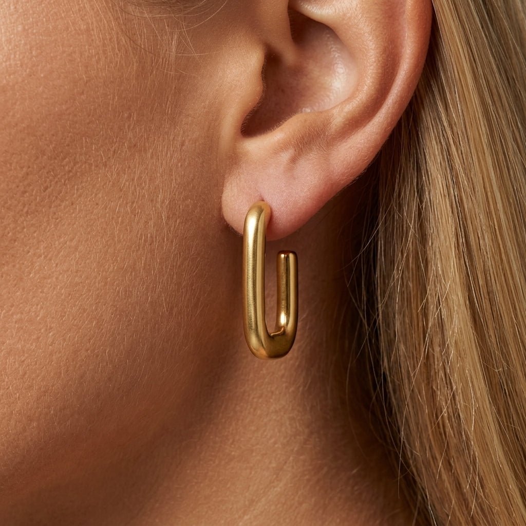 gold square hoop earrings elongated rectangular gold hoops with a sleek modern silhouette bold minimalist jewelry everyday luxe earrings