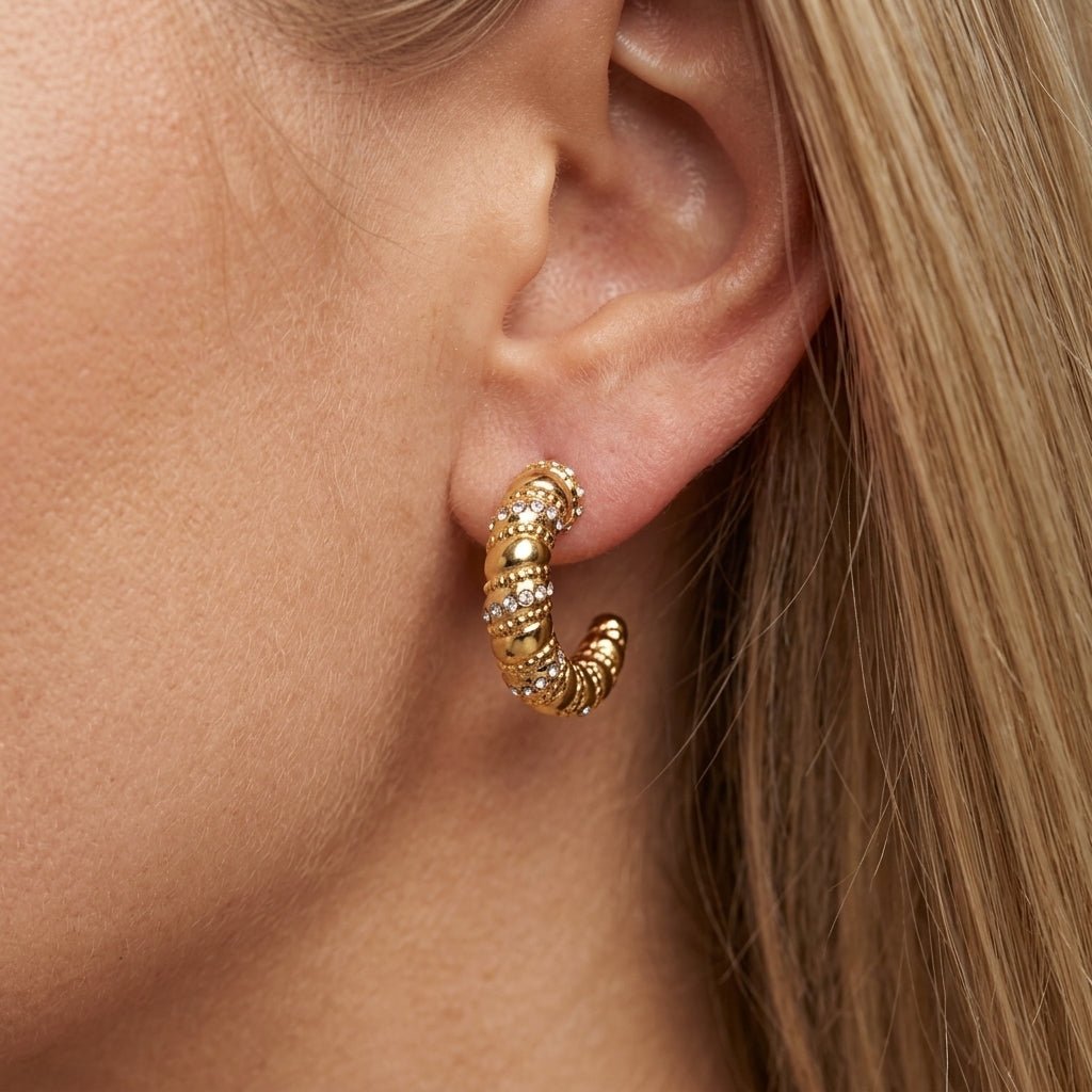 gold twist earrings bold gold hoop earrings with a twisted beaded design and shimmering crystal accents, creating a luxe statement look that blends vintage glamour with modern elegance for day-to-night styling
