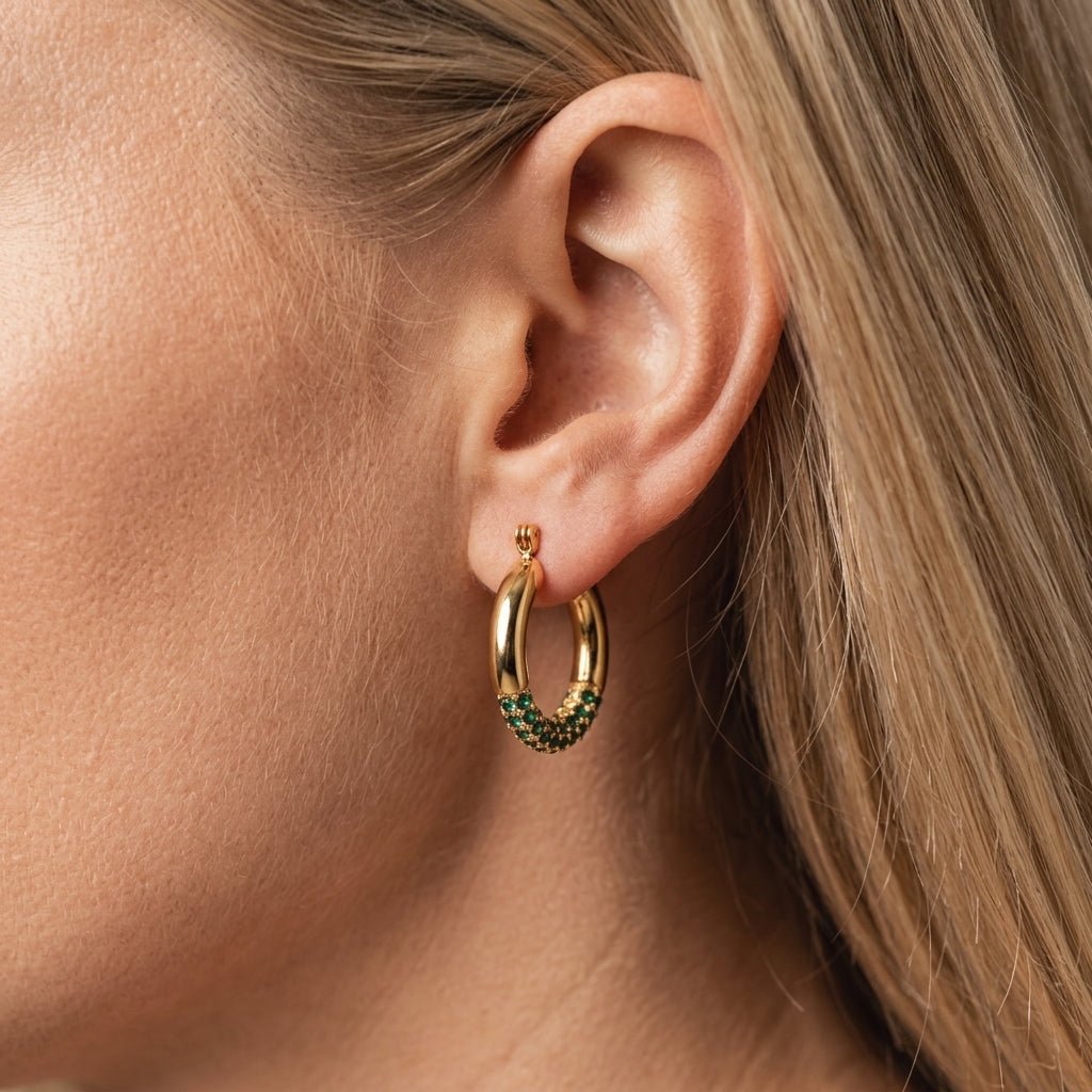 green and gold earrings polished gold hoop earrings featuring sparkling green crystal pavé detailing for a refined pop of color, designed with a sleek modern silhouette that adds effortless elegance to both casual and evening looks