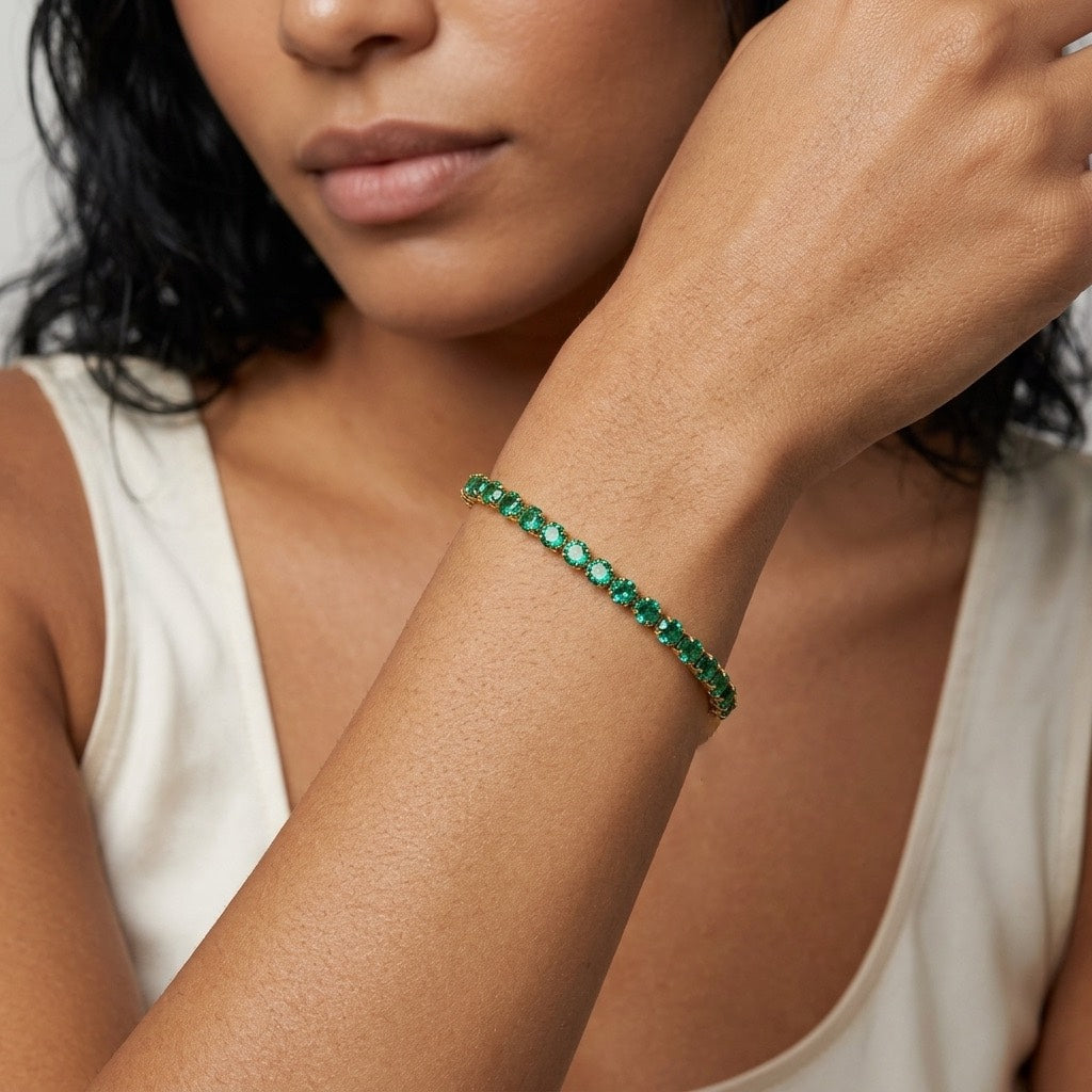 green cubic zirconia bracelet featuring sparkling emerald green stones set closely together in polished gold for elegant statement jewelry
