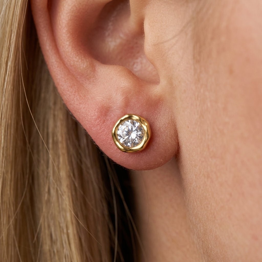 hammered gold stud earrings round crystal stud earrings set in an organic hammered gold bezel, combining subtle texture with a brilliant faceted stone for a timeless and effortlessly wearable design