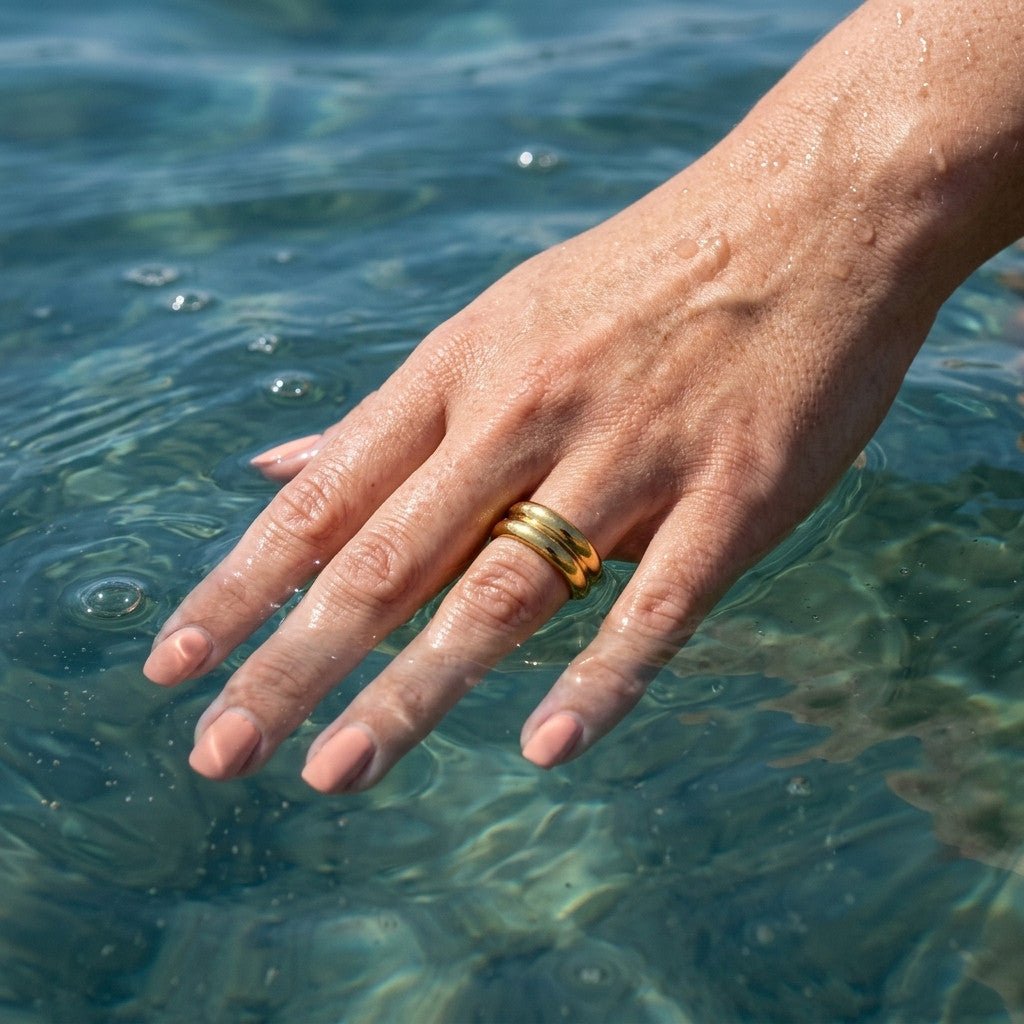 layered double band gold ring with rounded curves and a sleek polished design, worn on hand