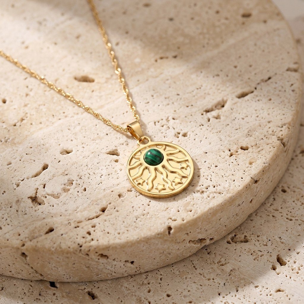malachite sun pendant necklace for women with a polished gold celestial design
