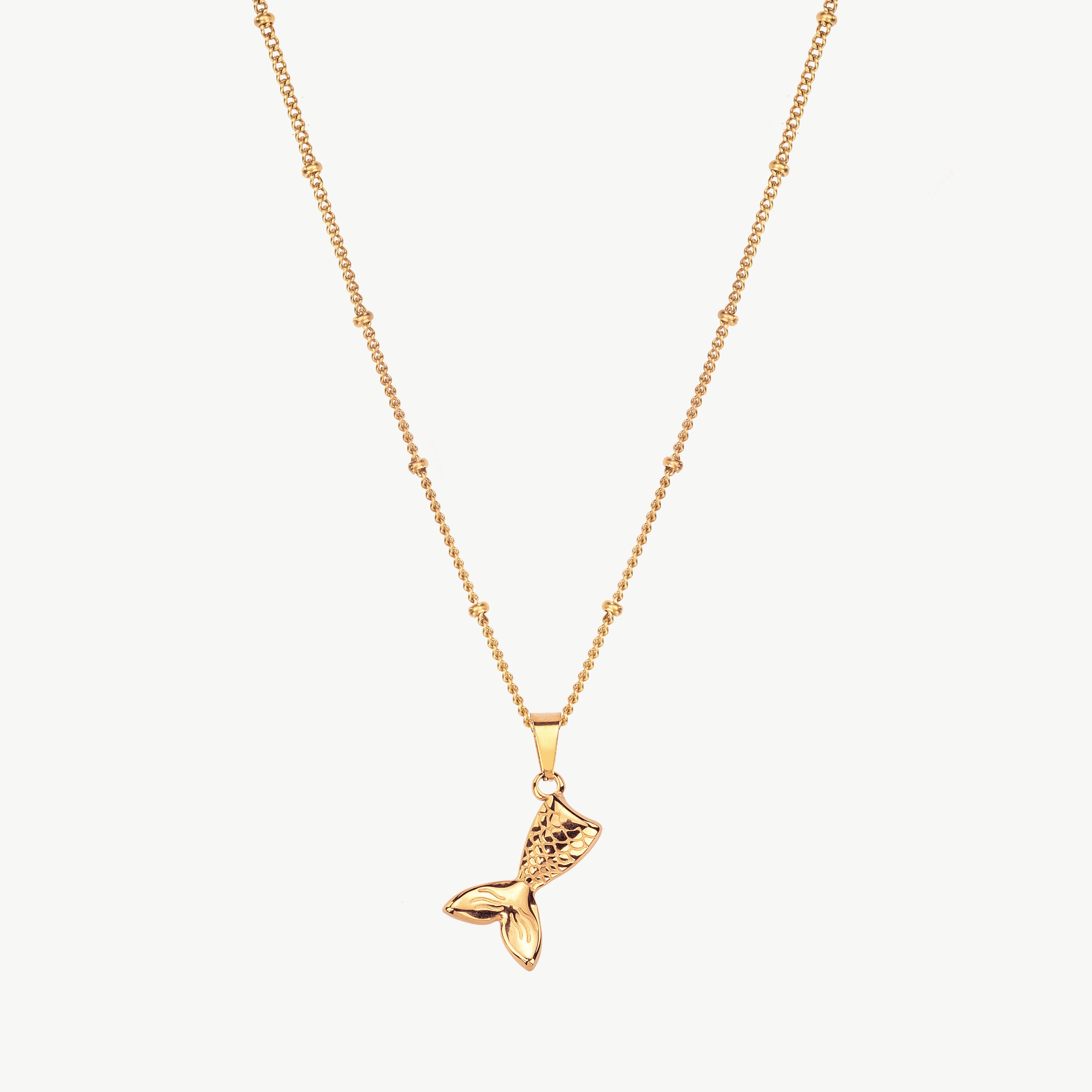 mermaid tail necklace in gold with curved tail pendant, gold mermaid tail necklace inspired by whale tail necklace and ocean shaped detailing