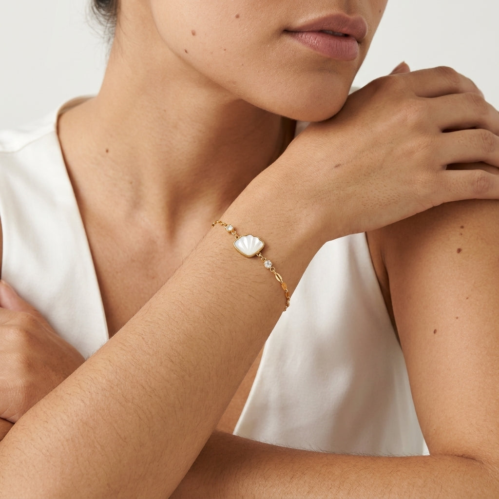 mother of pearl shell bracelet featuring a luminous white seashell charm framed in gold with delicate crystal details for elegant coastal jewelry styling