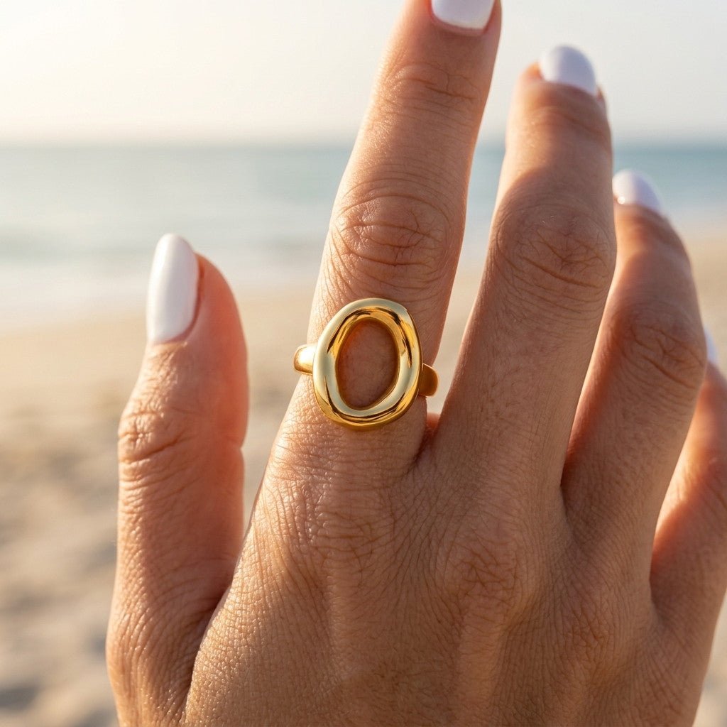 open center gold ring featuring a large oval silhouette and smooth polished finish