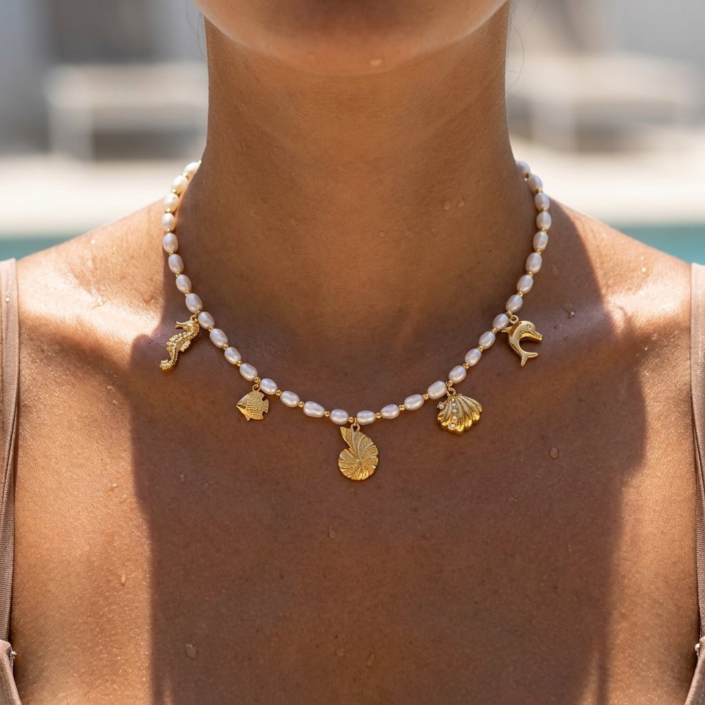 pearl beach charm necklace with gold seashell fish and seahorse charms