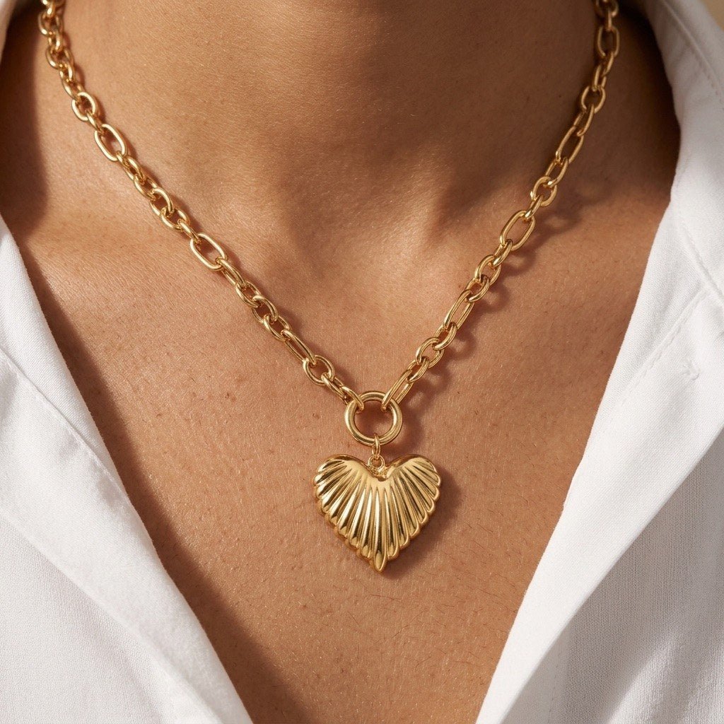 ribbed heart pendant necklace featuring a sculpted gold heart on an oval link chain