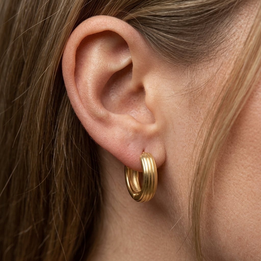 ribbed huggie earrings brushed gold huggie earrings with subtle ribbed detailing and a softly rounded modern-inspired design