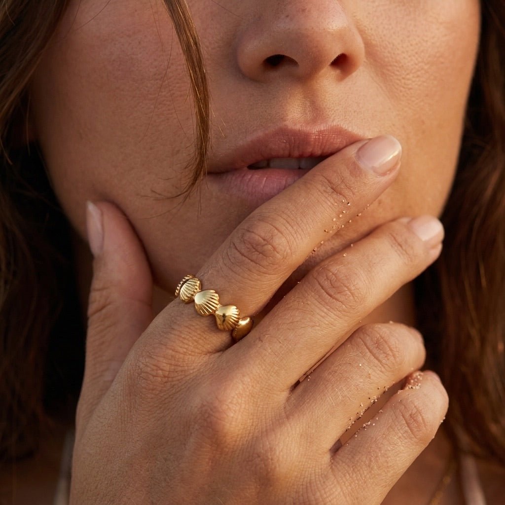 shell motif gold ring with detailed scallop shapes and a polished open band design