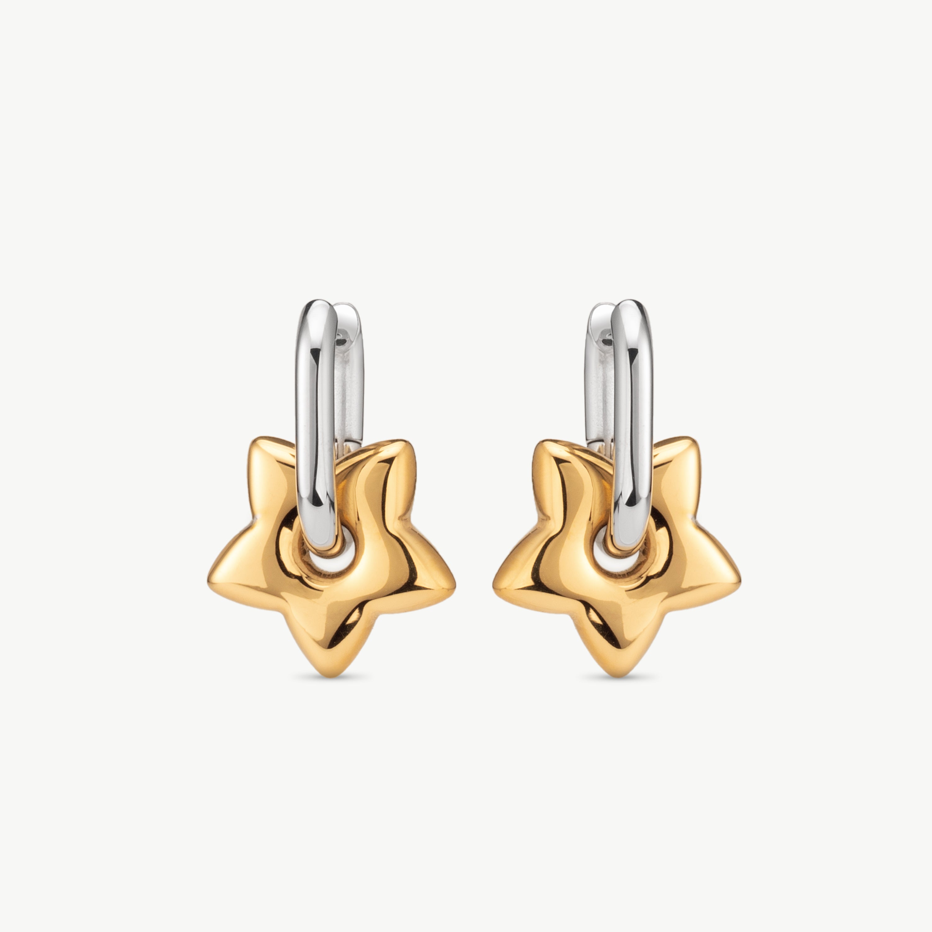 star hoop earrings in gold with dangling star charm detail, mixed metal hoop earrings and gold and silver hoop earrings styling