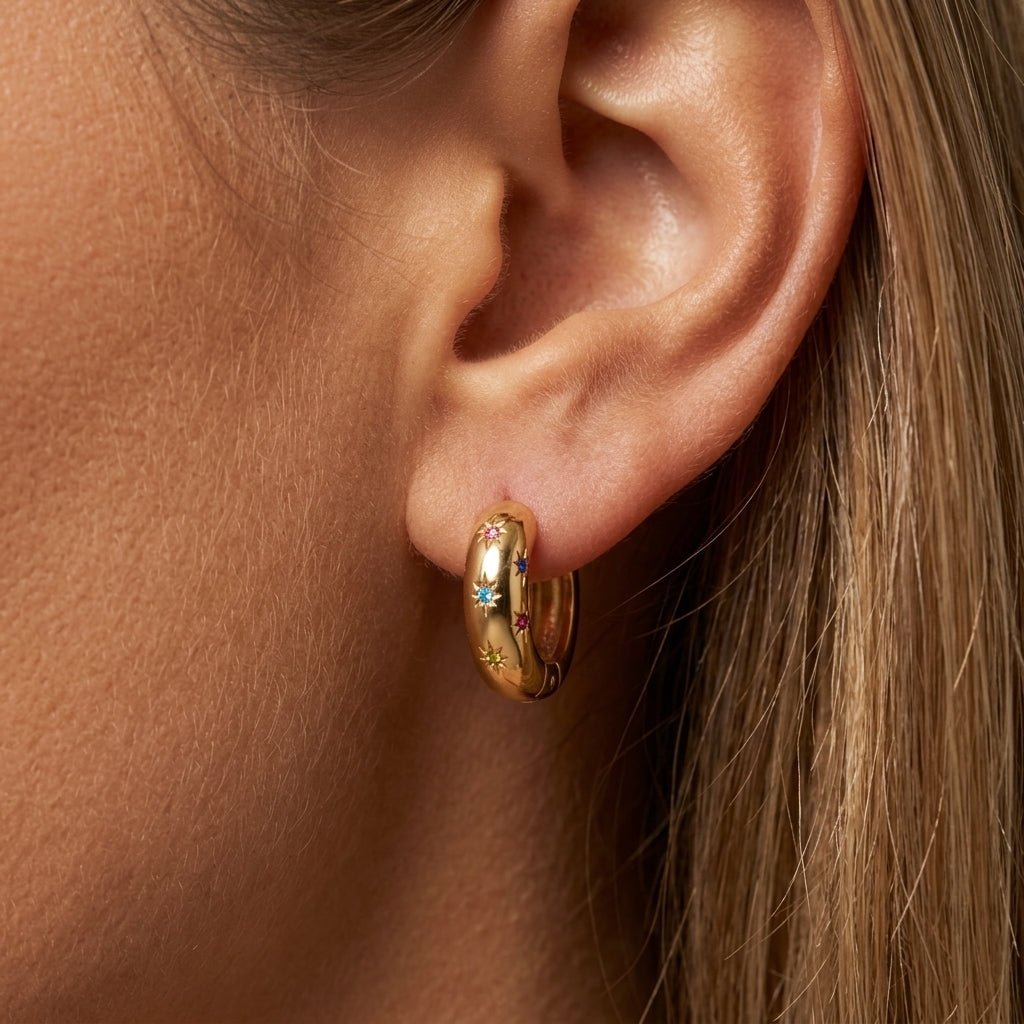 star huggie earrings polished gold huggie hoop earrings decorated with colorful crystal star details, blending playful celestial charm with a sleek modern finish for an effortlessly stylish everyday jewelry look
