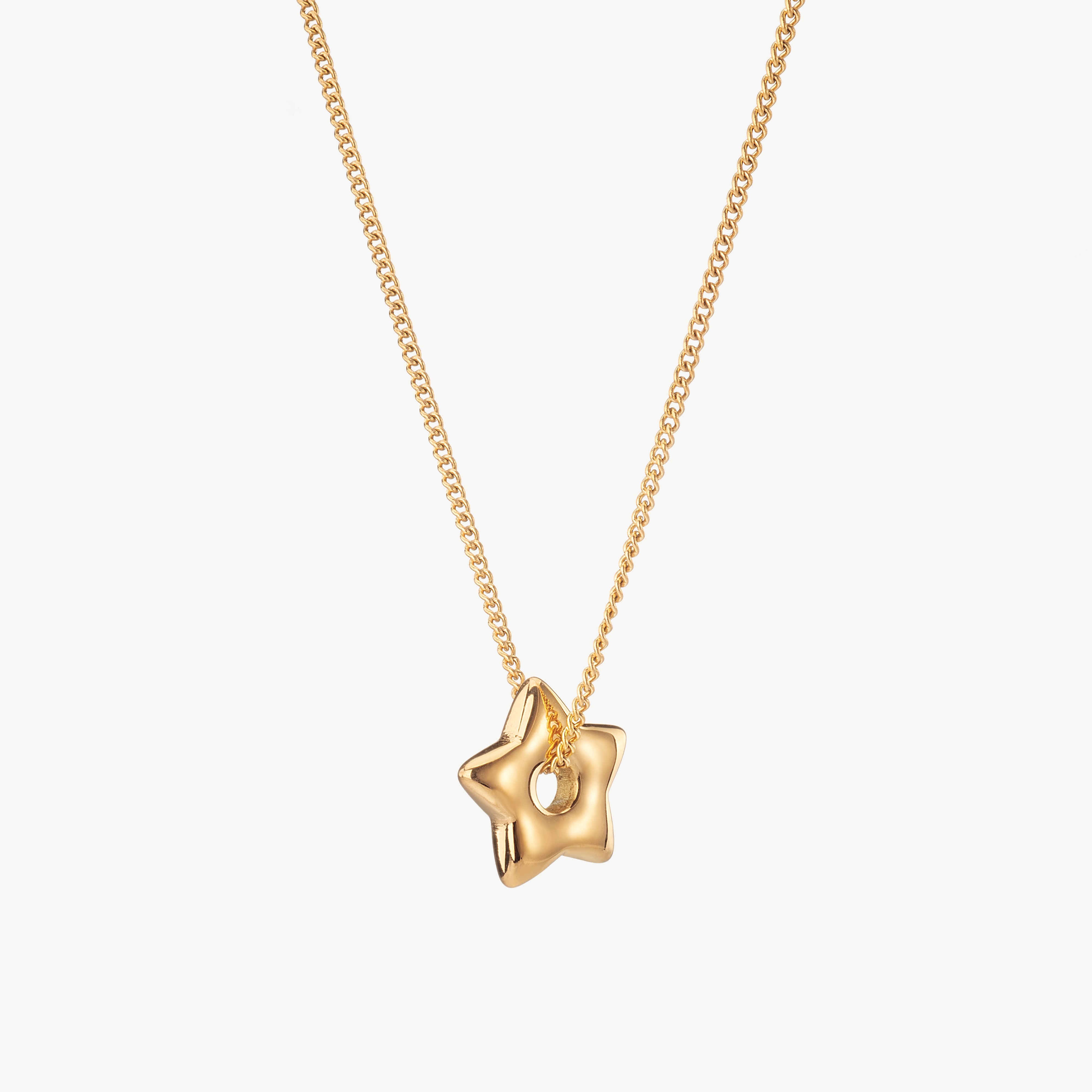 star pendant necklace in gold with sculpted star charm, gold star pendant necklace with celestial detail, chunky star necklace and puffy star necklace with polished reflective finish