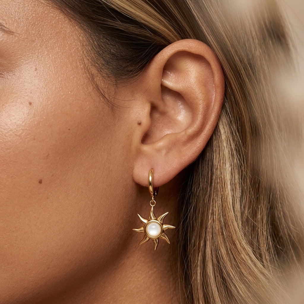 sun earrings for women with a gold sunburst and pearl detail