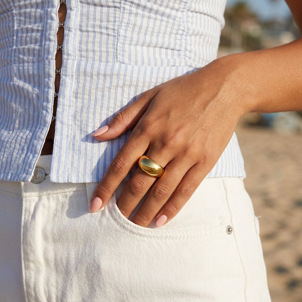 thick gold band with a polished finish and substantial curved profile, worn on hand