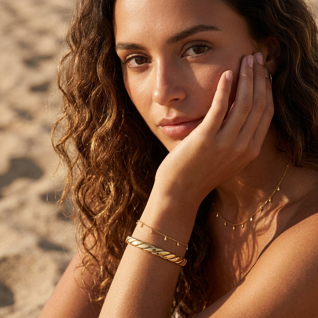 twisted gold bangle bracelet featuring a sleek spiral design with raised diagonal ridges and a polished gold finish for sophisticated minimalist jewelry