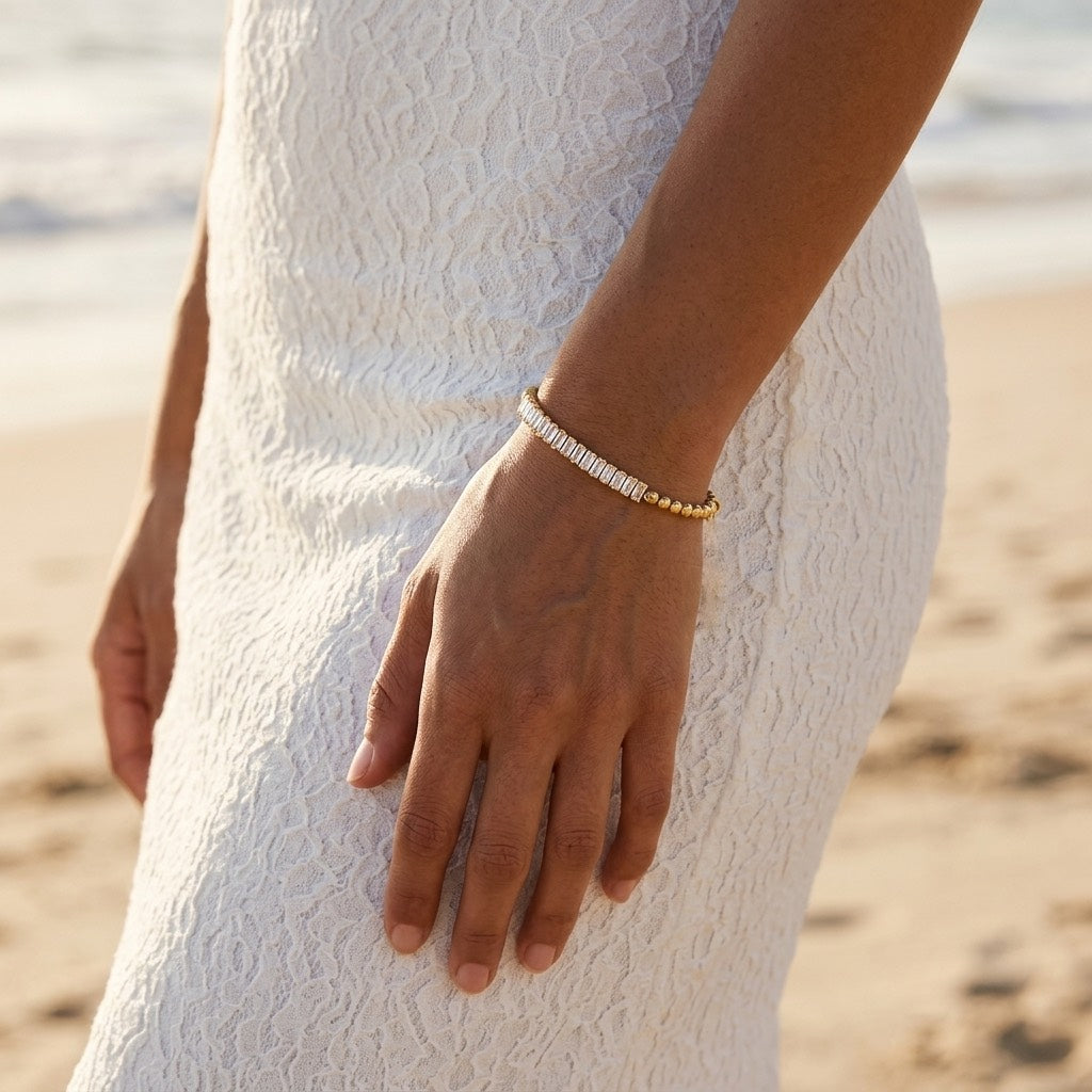 two tone texture gold bracelet featuring contrasting sections of sparkling baguette cut cubic zirconia stones and smooth gold beads for a distinctive modern jewelry design